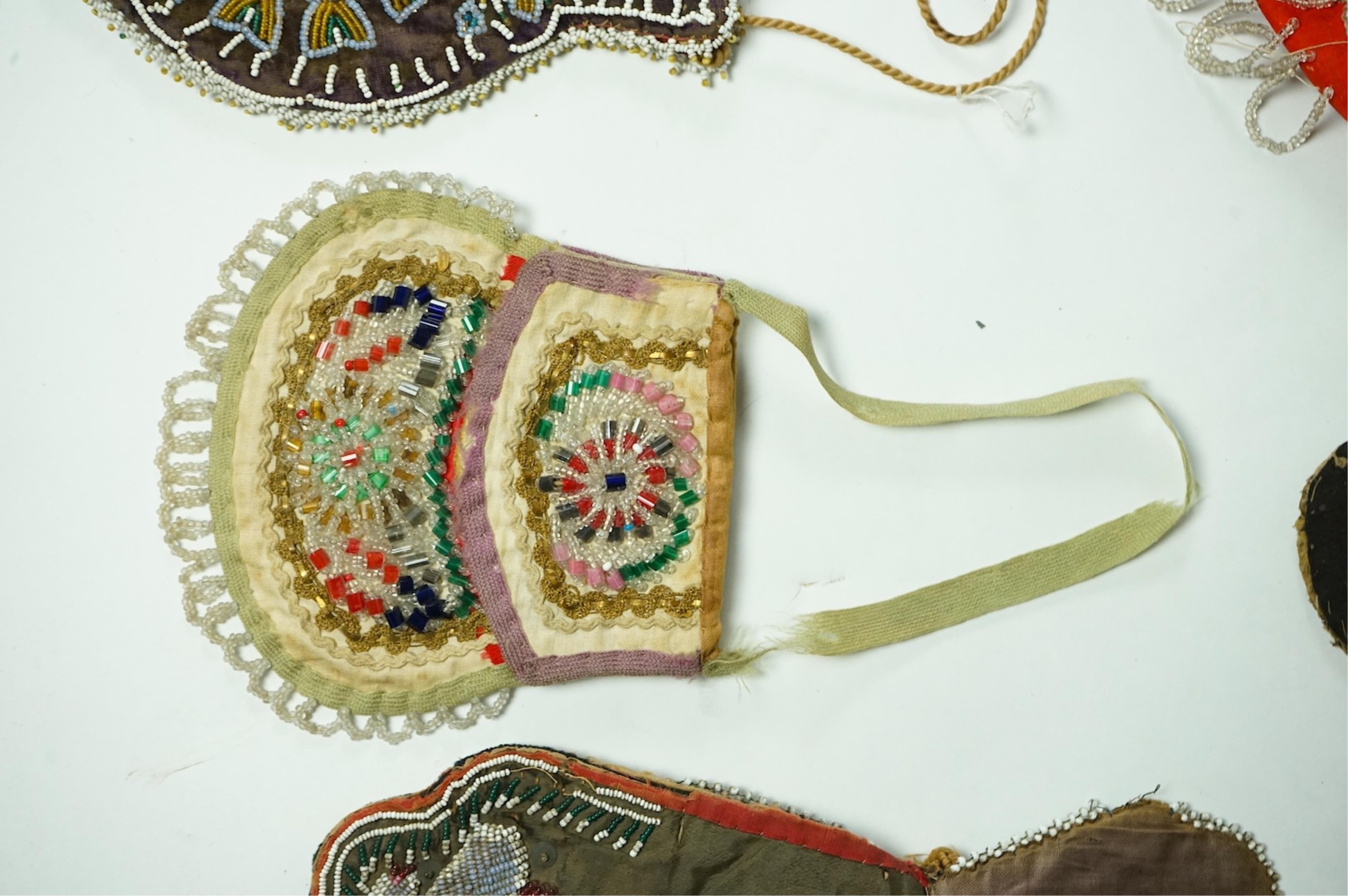 Five 19th century Native American beaded bags. Including a red felt coin pouch, three varying sized bags and a beaded panel.(5) Condition - four have damage to the fringing and beading and backing cloth. The light bag th